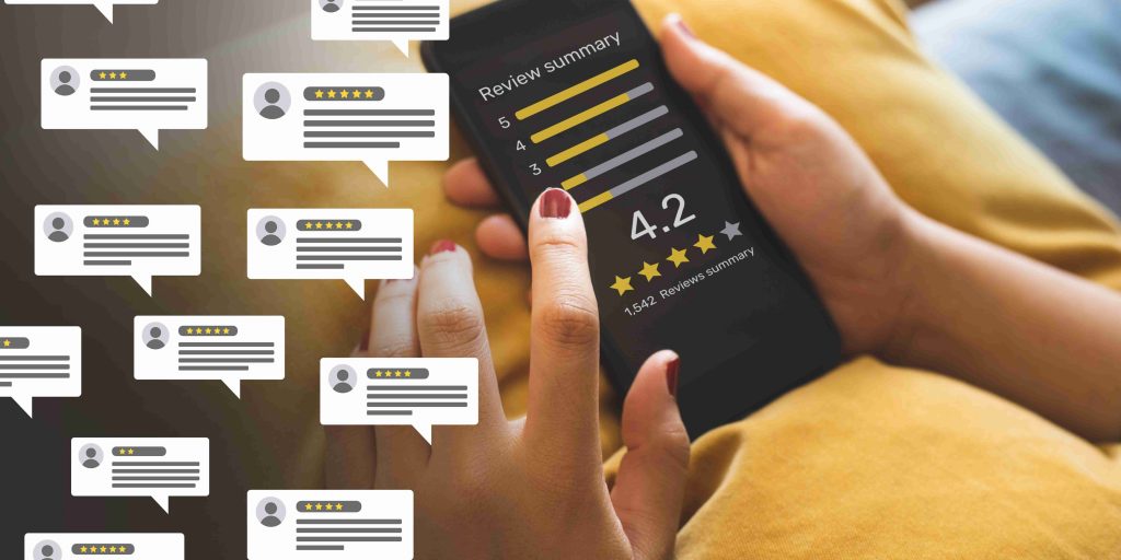 A cellphone showing a review summary on the screen with a 4.2 star rating